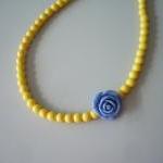 Yellow necklace with blue r..